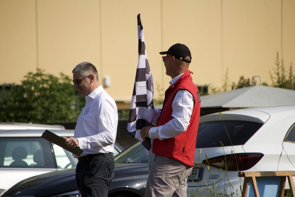 Organisers with a chequered flag at the event start