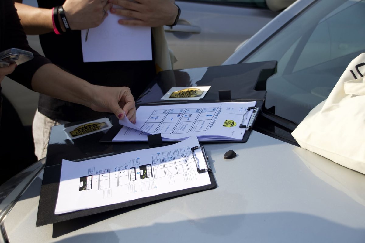 Printed roadbooks on clipboards at a rally event